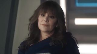 Deanna Troi listening to Data when he's in therapy. She's wearing all black. 