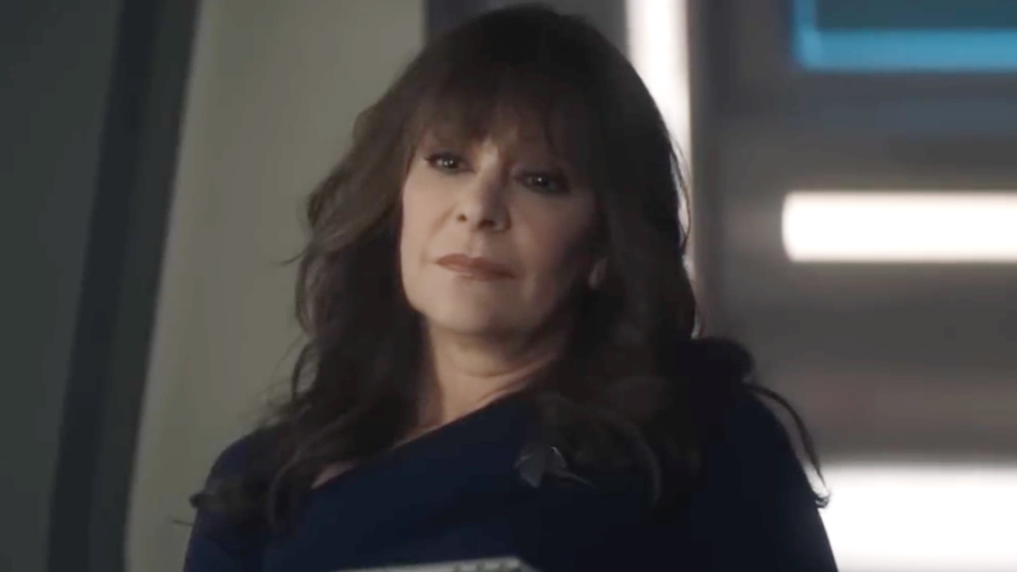 Deanna Troi listening to Data when he's in therapy. She's wearing all black. 