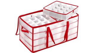 A semi-transparent plastic ornament storage box with red stripes and red handles with a removable tray on top, for best ornament storage containers.