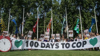 Activists hold banners and placards in Parliament Square