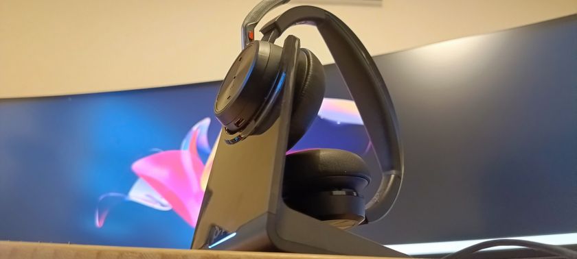 A pair of Poly Voyager Focus 2 headphones on a wooden desk