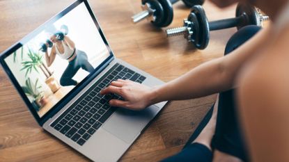 A product shot of a woman using one of the best weightlifting apps