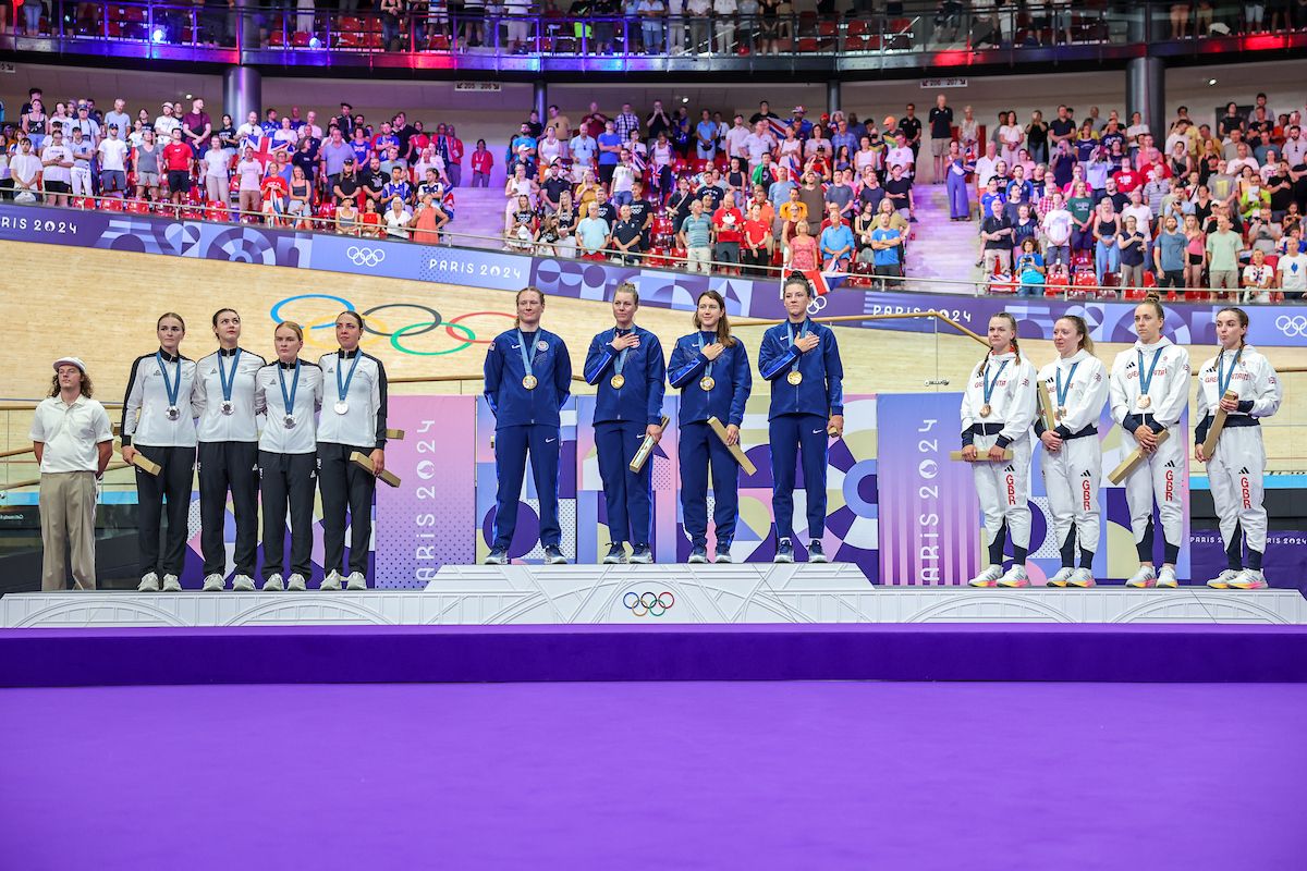 Picture by Alex Whitehead/SWpix.com - 07/08/2024 - Paris 2024 Olympic Games - Track Cycling - National Velodrome, Saint-Quentin-en-Yvelines, France - Women&acirc;s Team Pursuit - Jennifer Valente, Lily Williams, Chloe Dygert, Kristen Faulkner (USA) on the podium receiving the Olympic Gold Medal after winning the Women's Team Pursuit to become Olympic Champions with Ally Wollaston, Bryony Botha, Emily Shearman, Nicole Shields (New Zealand) receives the Olympic Silver Medal and Elinor Barker, Josie Knight, Anna Morris, Jessica Roberts (Great Britain) receives the Olympic Bronze Medal