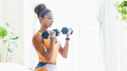 Woman doing biceps curls with a dumbbell