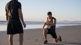 Luke Zocchi training Chris Hemsworth on a beach