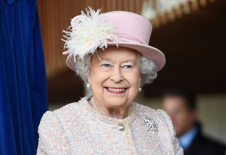 A close-up of the Queen smiling, who is responsible for the extra bank holiday in 2022