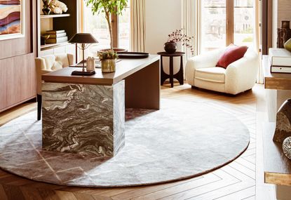 A round rug under a home desk