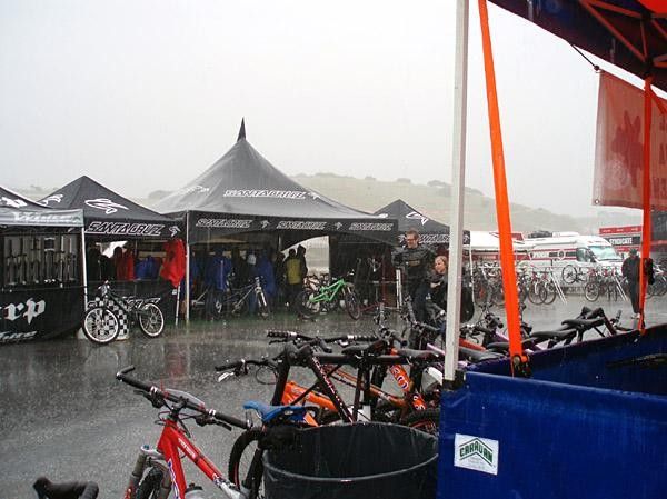 People huddle under tents