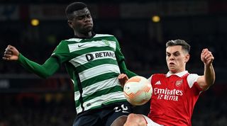 Sporting Lisbon's Ivory Coast defender Ousmane Diomande (L) vies with Arsenal's Belgian midfielder Leandro Trossard during the UEFA Europa League round of 16, second-leg football match between Arsenal and Sporting Lisbon at the Emirates Stadium in London on March 16, 2023.