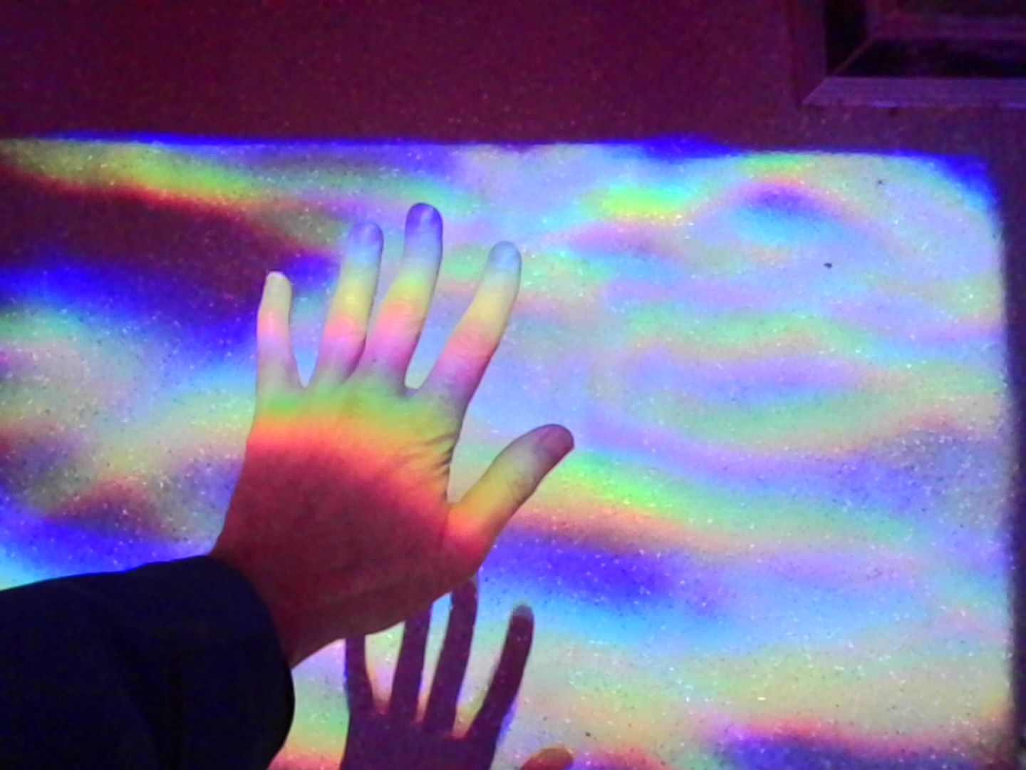 Kodak Charmera sample gallery: a hand illuminated by rainbow lights