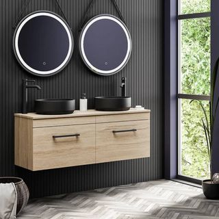 Wood effect vanity unit in modern bathroom with matt black sinks and taps