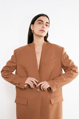 Model wears Aeron Pre-Fall 2021 brown suit jacket