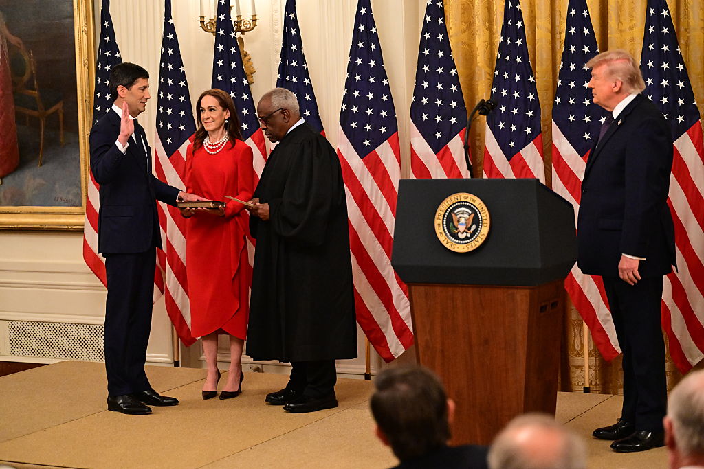 Kevin Warsh takes the oath of office from U.S. Supreme Court Associate Justice Clarence Thomas as President Donald Trump looks on
