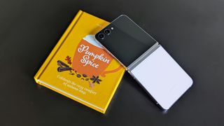The Galaxy Z Flip 5 on a coffee table book