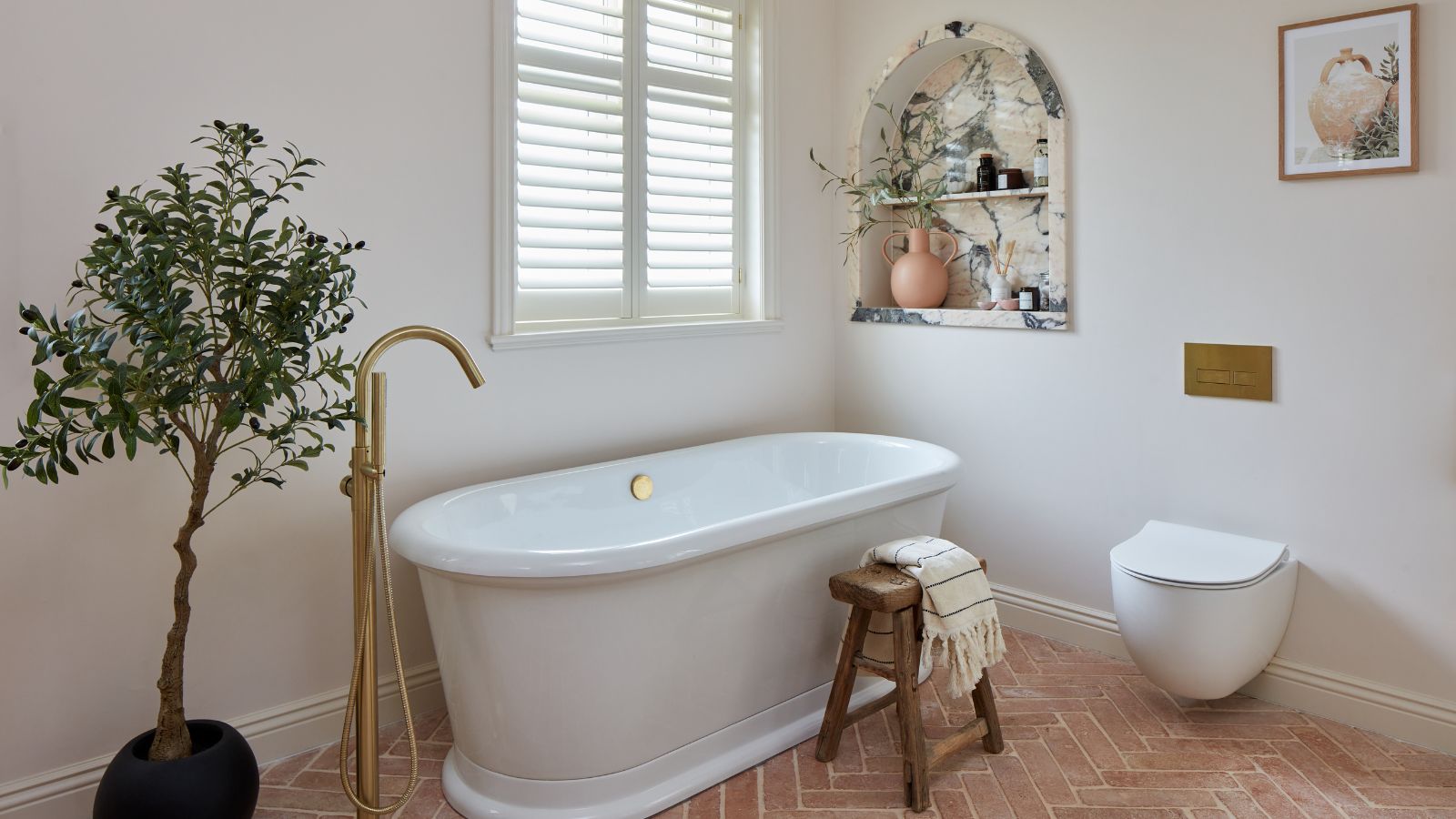 Mediterranean bathroom with terracotta floor tiles and a marble shower