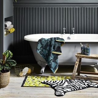 bathroom with wooden flooring and printed zebra towels
