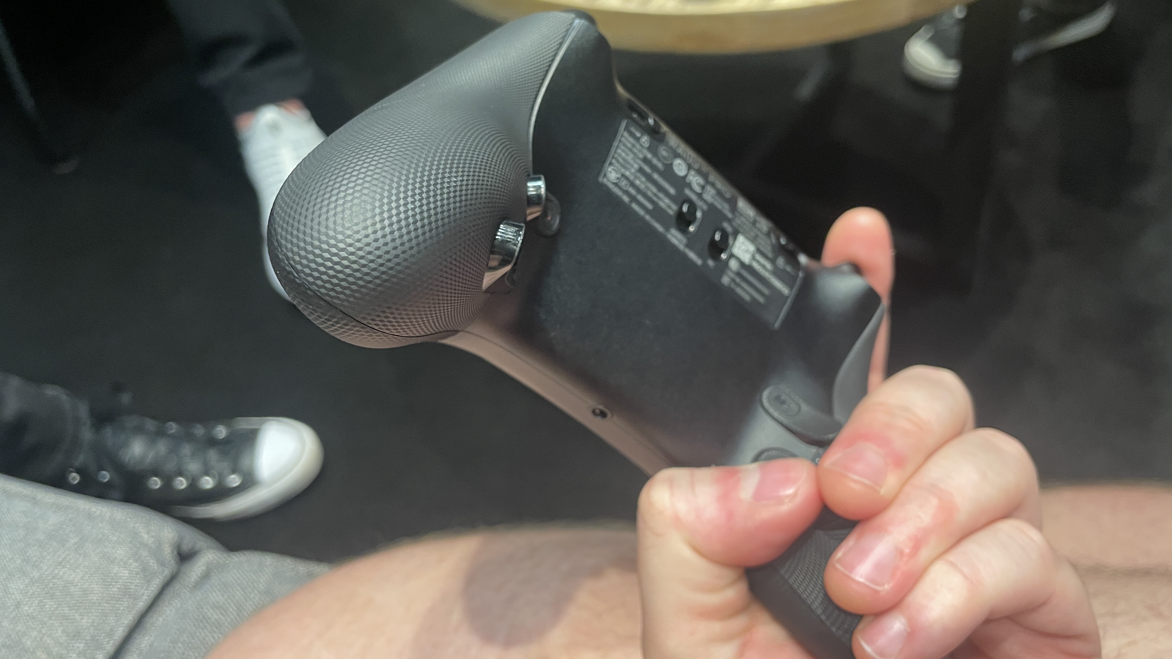 Holding a Razer Raiju V3 Pro controller