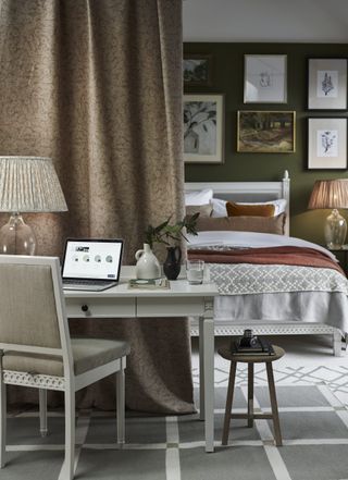 A curtain makes a great divider in this home office bedroom