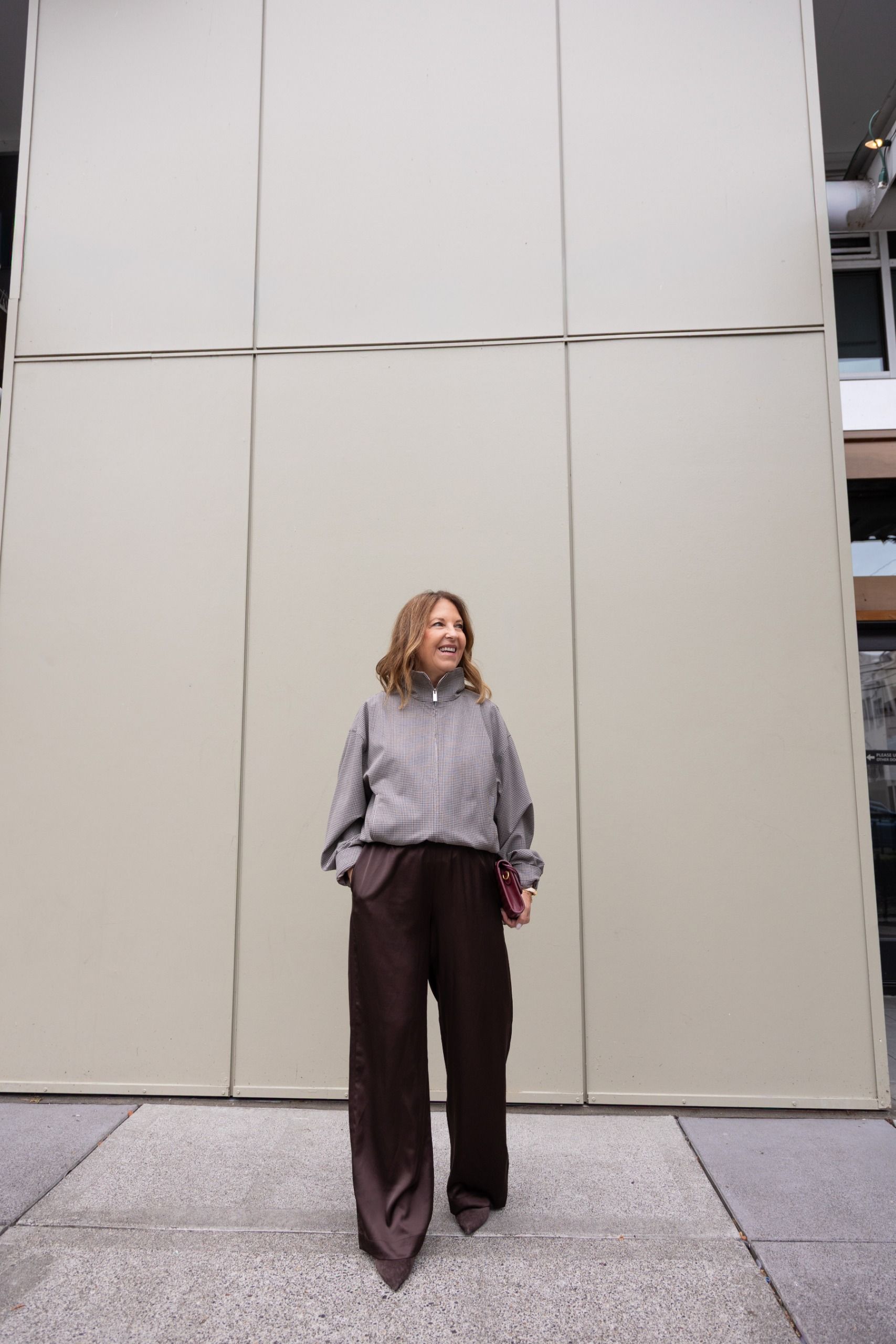 Sandy Koszarek wearing a track jacket and brown trousers.