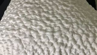 Up close image showing the texture and design of the cover of the side sleeper pillow