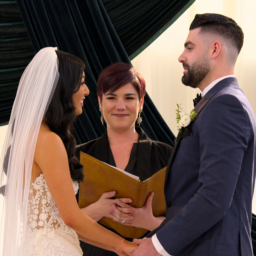 emma and mike at the altar holding hands during their wedding in love is blind season 10