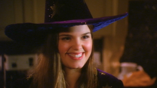 Kimberly J. Brown smiling while in a witches hat in Halloweentown II: Kalabar's Revenge