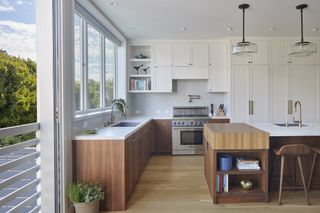 Kitchen and dining at The Fourth Wall house by SAW