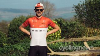 Cyclist posing outside wearing Le Col Lion of Flanders kit