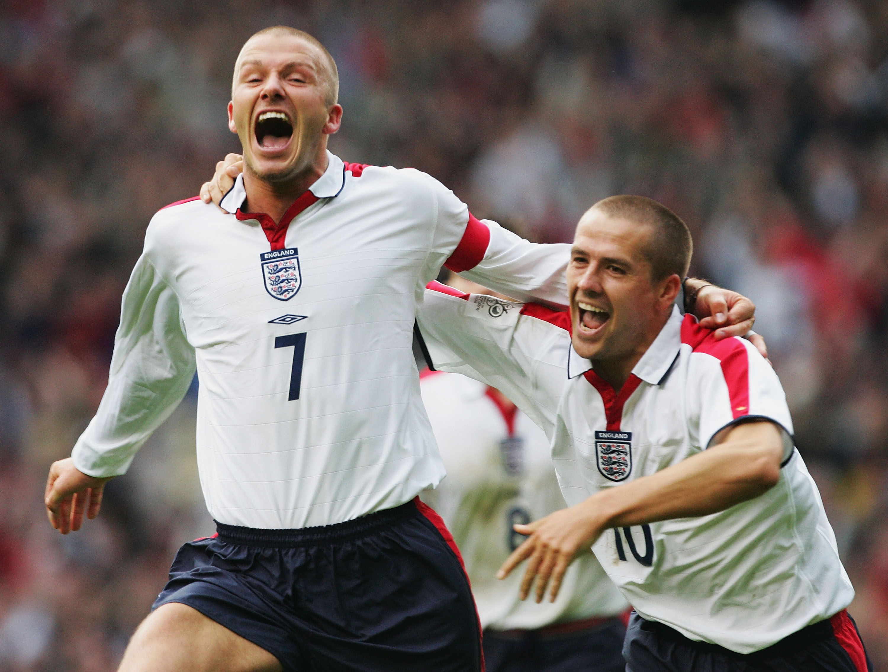 David Beckham celebrates with Michael Owen after scoring a wonderful goal for England against Wales in a World Cup qualifier at Old Trafford in October 2004.