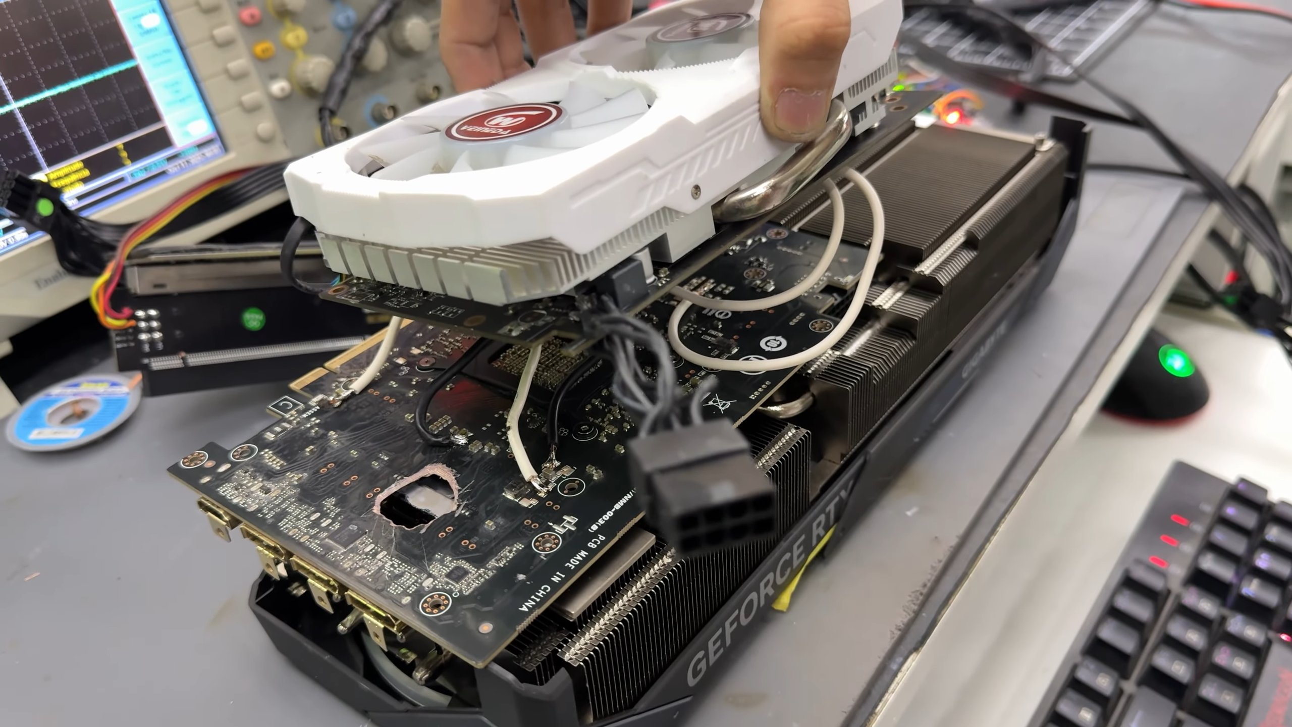 Dead RTX 5070 Ti with a hole burnt through its PCB