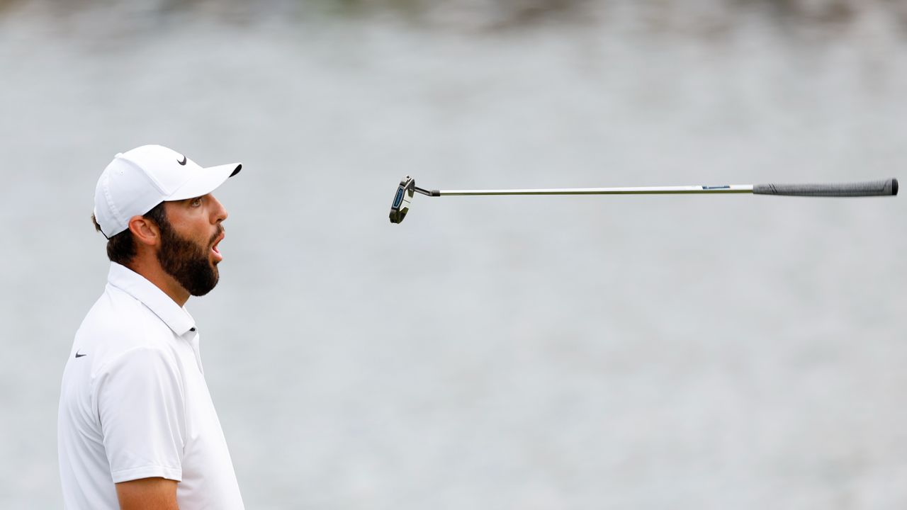 Scottie Scheffler tosses his putter in the air after missing a putt at the Players Championship