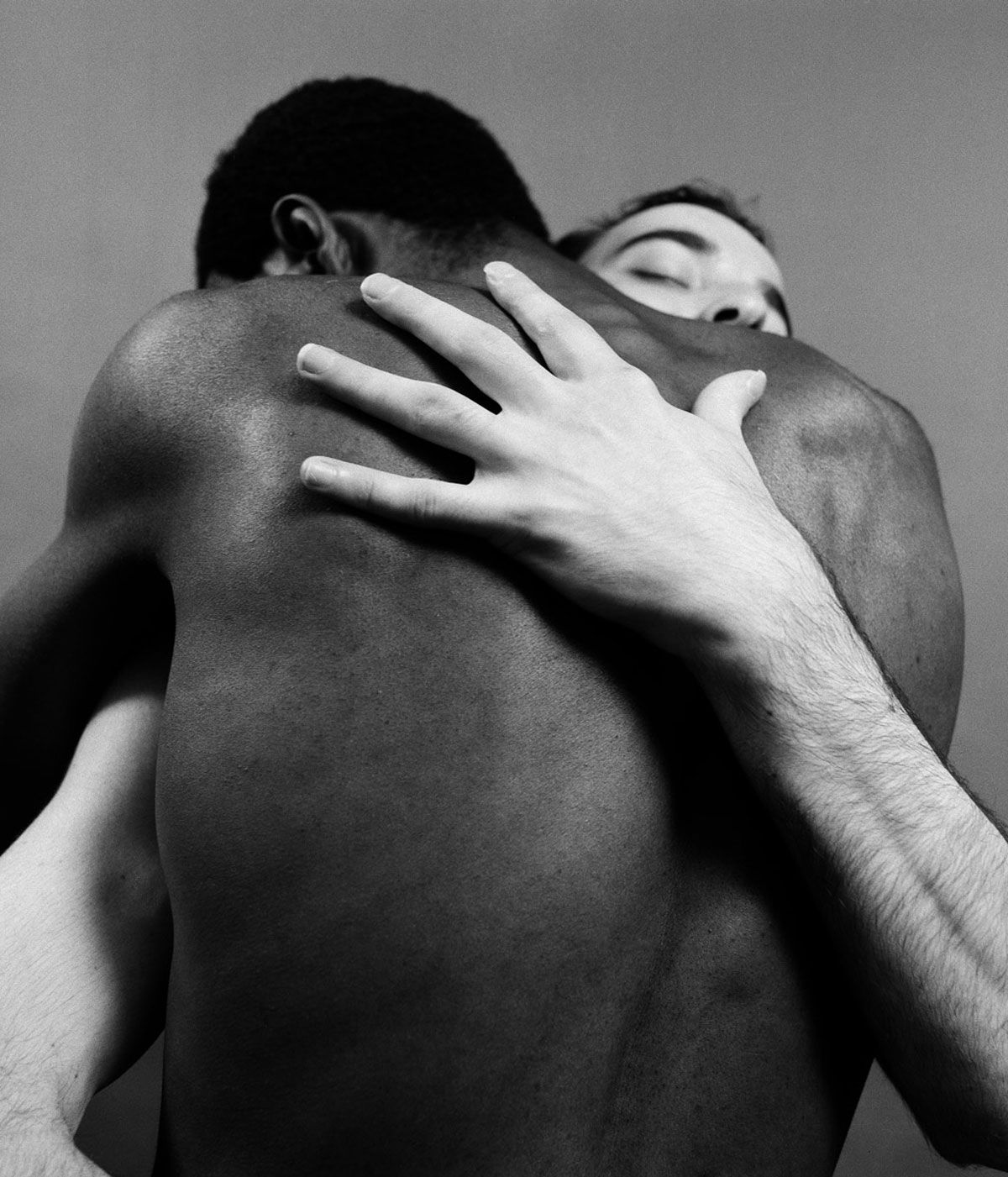 black and white men hugging 