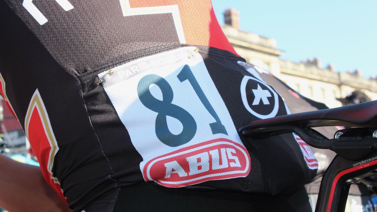 The numbers stick on, but many riders pin them anyway