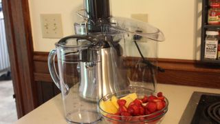 Breville Juice Fountain Cold Plus with a bowl of strawberries and pineapple