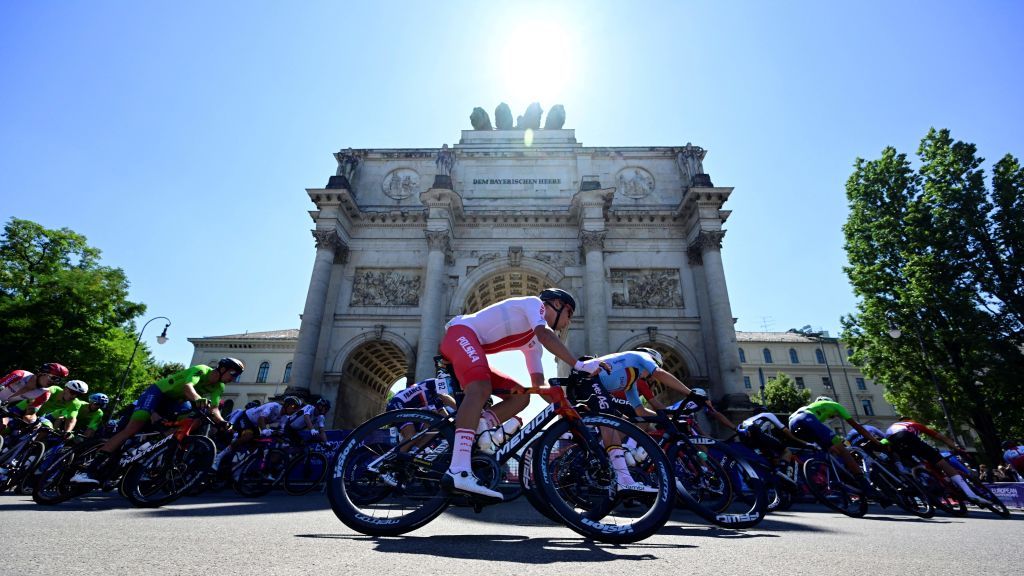 Polands Filip Maciejuk and other cyclists make their way past the Victory Gate Siegestor as they compete during the mens road race cycling event of the European Championships Munich 2022 in Munich southern Germany on August 14 2022 Photo by John MACDOUGALL AFP Photo by JOHN MACDOUGALLAFP via Getty Images