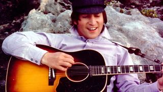 John Lennon playing Gibson J-160E in 1964