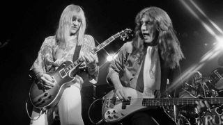 Rush’s Alex Lifeson and Geddy Lee performing onstage in 1976