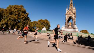 Runners in the Royal Parks Half Marathon run past the Albert Memorial in Kensington Gardens, London