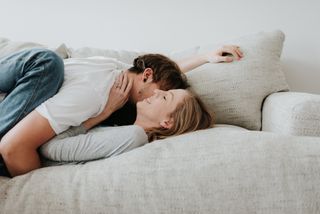 Morning after pill side effects: A couple kissing on a sofa