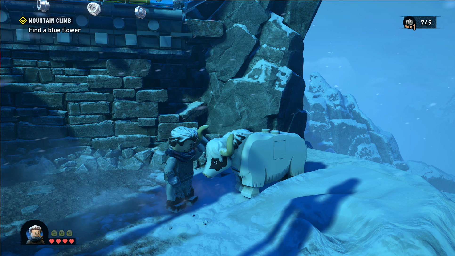Bruce Wayne pets a yak in the mountains near the League of Shadows