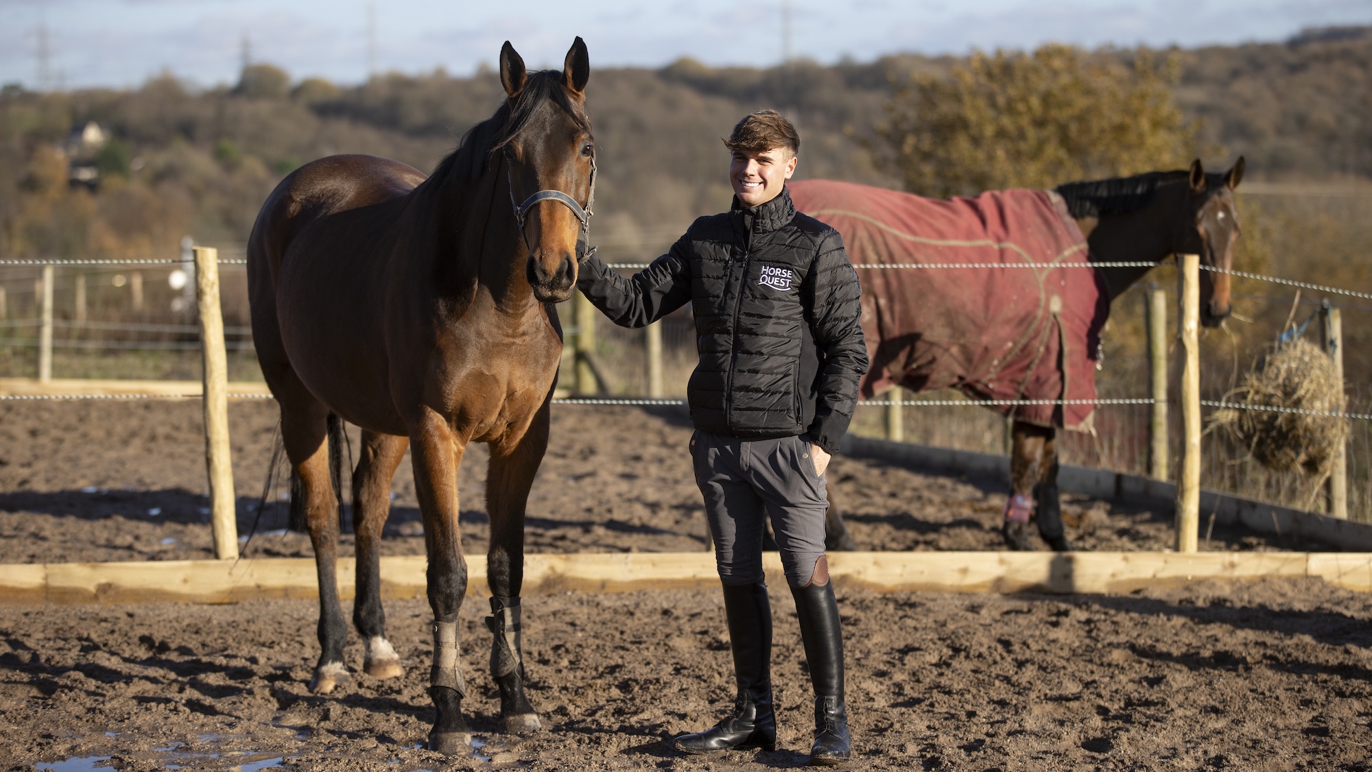 Harrison Taylor with young horse in field.