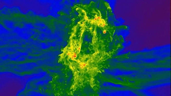 A supercomputer simulation shows massive stars forming (red) in a cloud of ancient gas. 