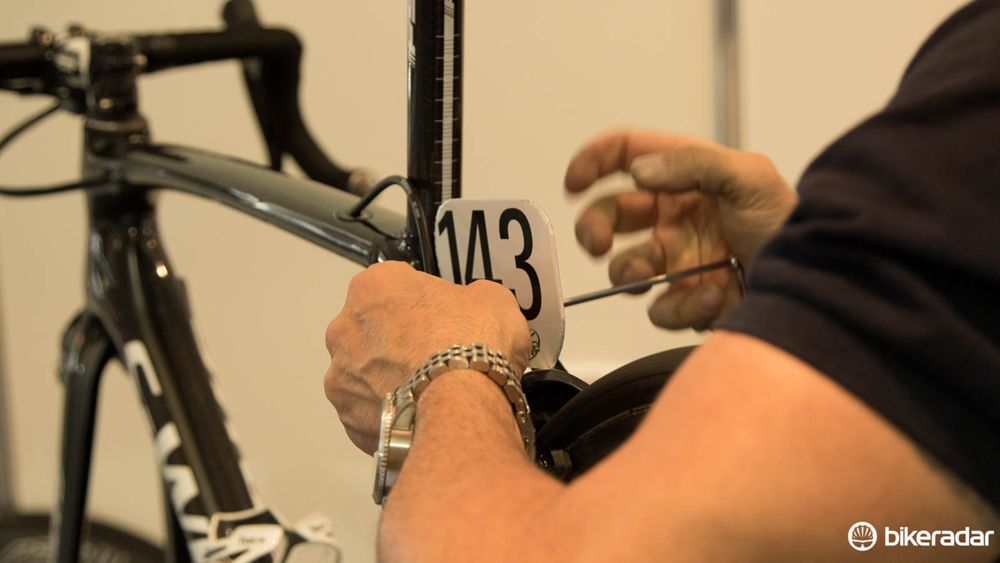 Most teams have their own ways of mounting race numbers to bikes. A bolt-on mount is probably the most common