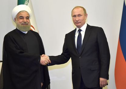 Iran's Rouhani shakes hands with Russia's Vladimir Putin