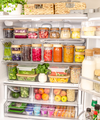 A colorful, well-organized fridge with fresh produce and jars of food organized by color