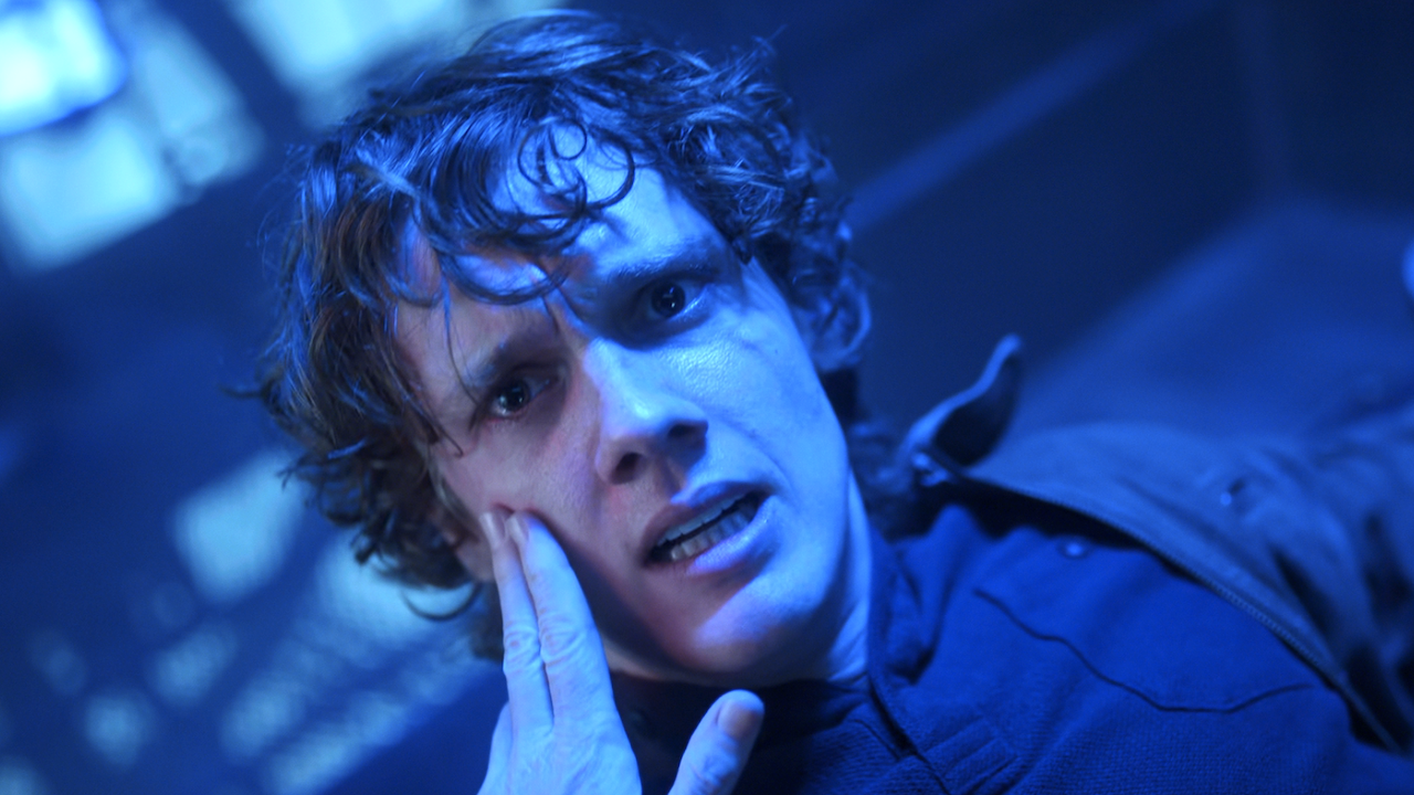 'Hunter Doohan as Tyler Galpin with blue lights around him in Wednesday Season 2 finale 