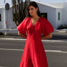 Woman wears red whistles dress