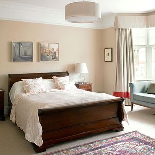 main bedroom in edwardian home with pink walls and sleigh bed