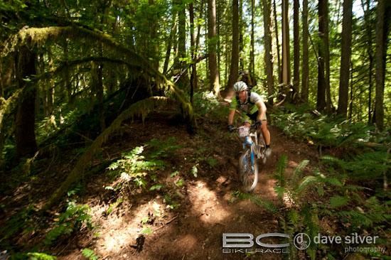 A rider enjoys the shaded singletrack.