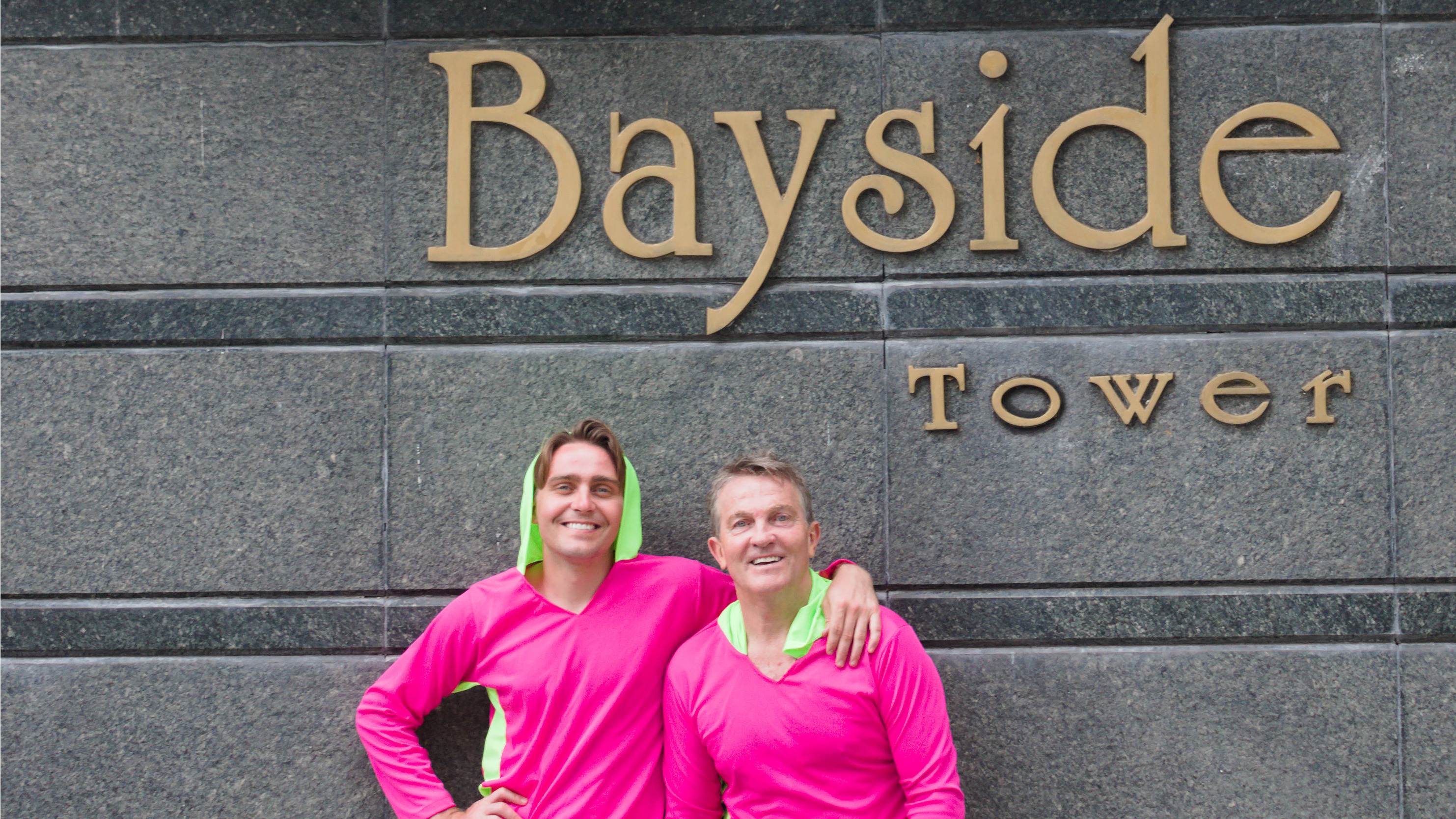 Bradley and Barney stand in front of the Bayside Tower sign in Panama
